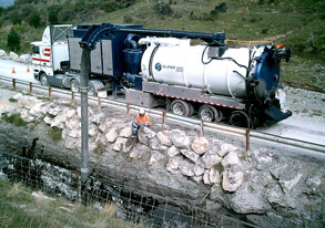 Hydro excavator operator at work on a roadside construction site